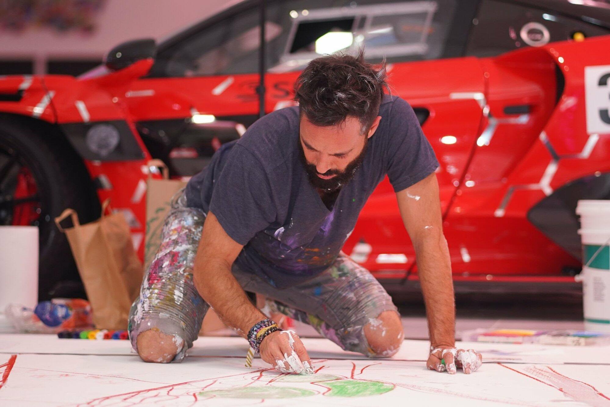 Artist Sacha Jafri painting during the event at Ikonick
